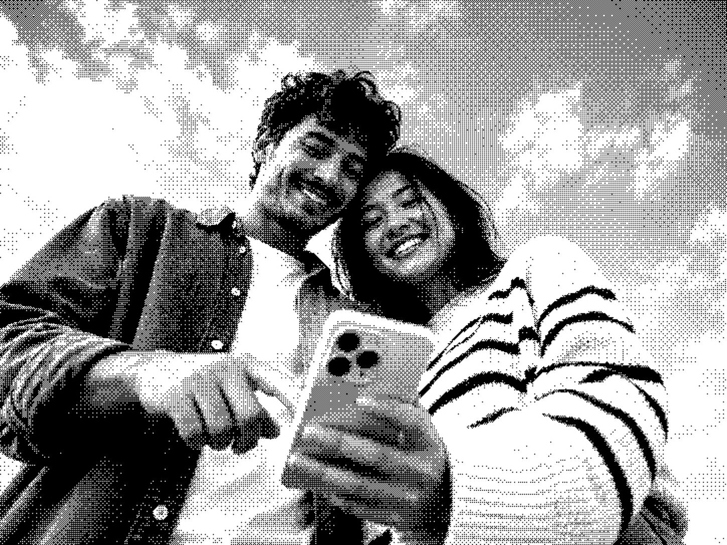 A couple looking at a phone together outdoors